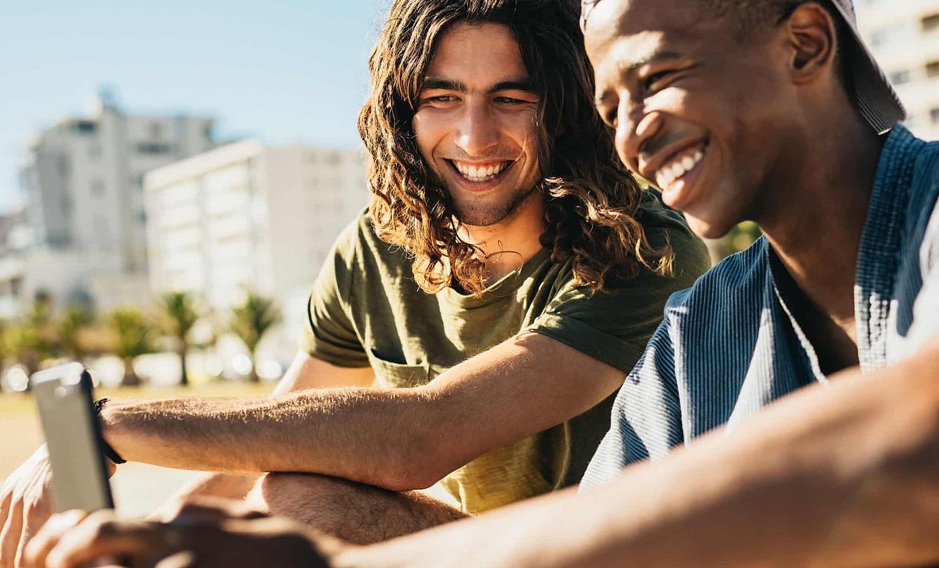 Friends using a mobile phone outdoors