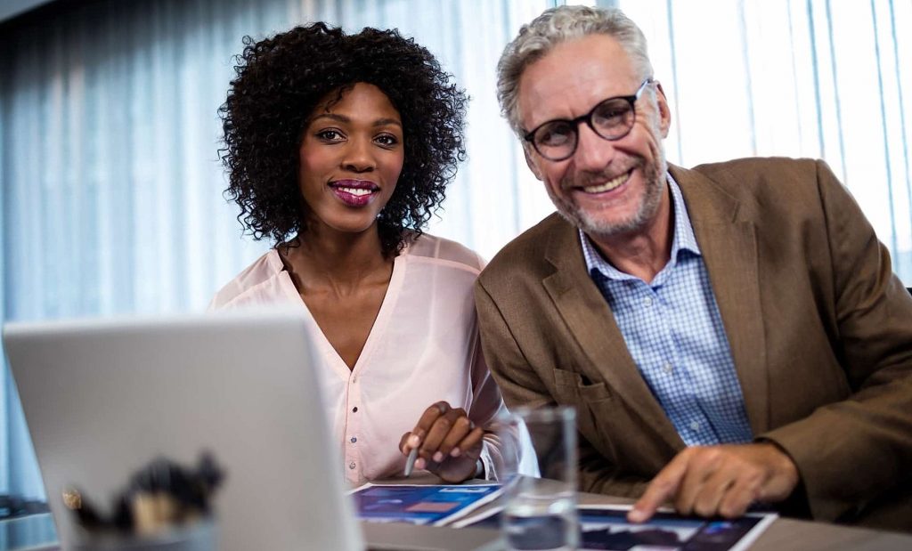 Two businessmen at work smiling